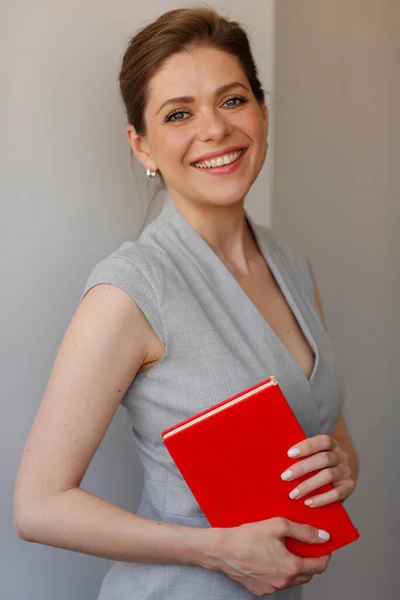 Woman teacher with red book. Isolated person portrait.