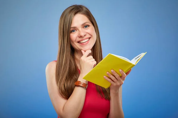 Student woman in red dress holding open yellow book  Isolated female person portrait on blue background.