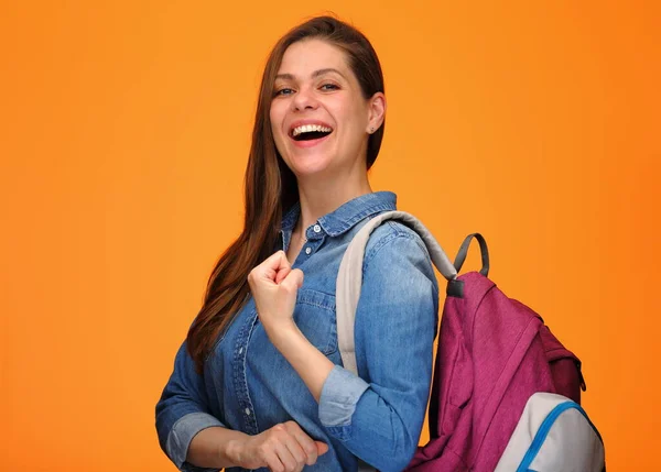 Student woman female power holding book, young lady with backpack isolated portrait on orange back.