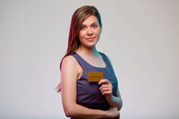 Woman holding gold credit card, isolated portrait of bank employee.