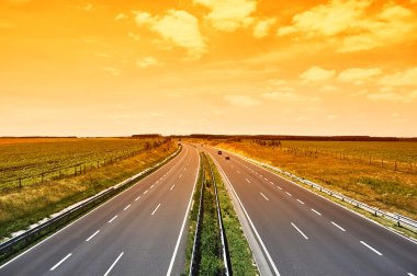 Four-lane motorway in sunset, Hungary clipart
