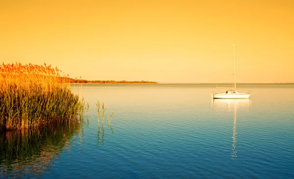 Sailboat on Lake Balaton in sunrise — Stock Photo, Image