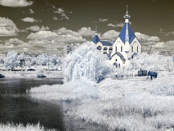 Church ashore lake. Temple of All Saints in earth Russian. Infra — Stock Photo, Image