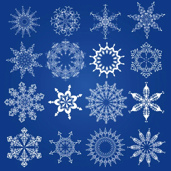 Flocos de neve, elementos de design de Natal em um fundo azul — Vetor de Stock