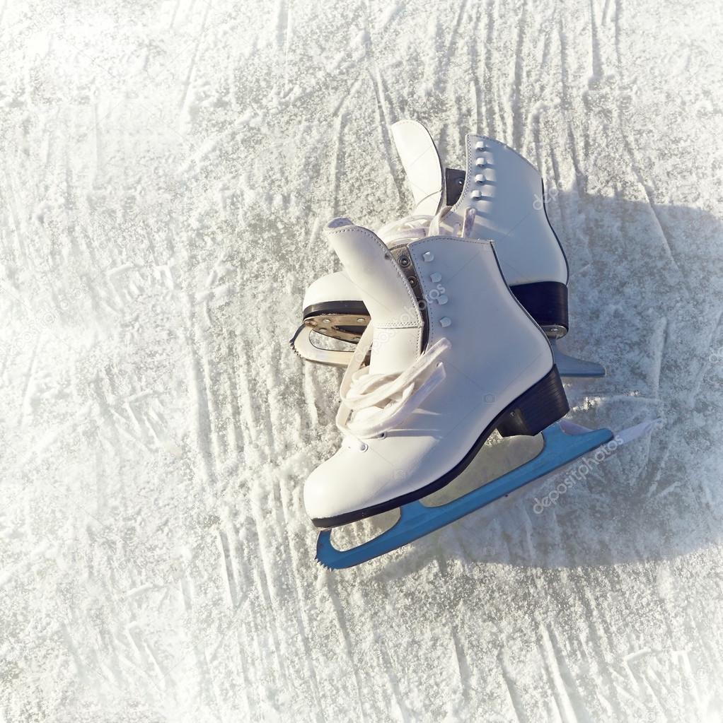 Women white skates. Abstract background on a winter sports theme