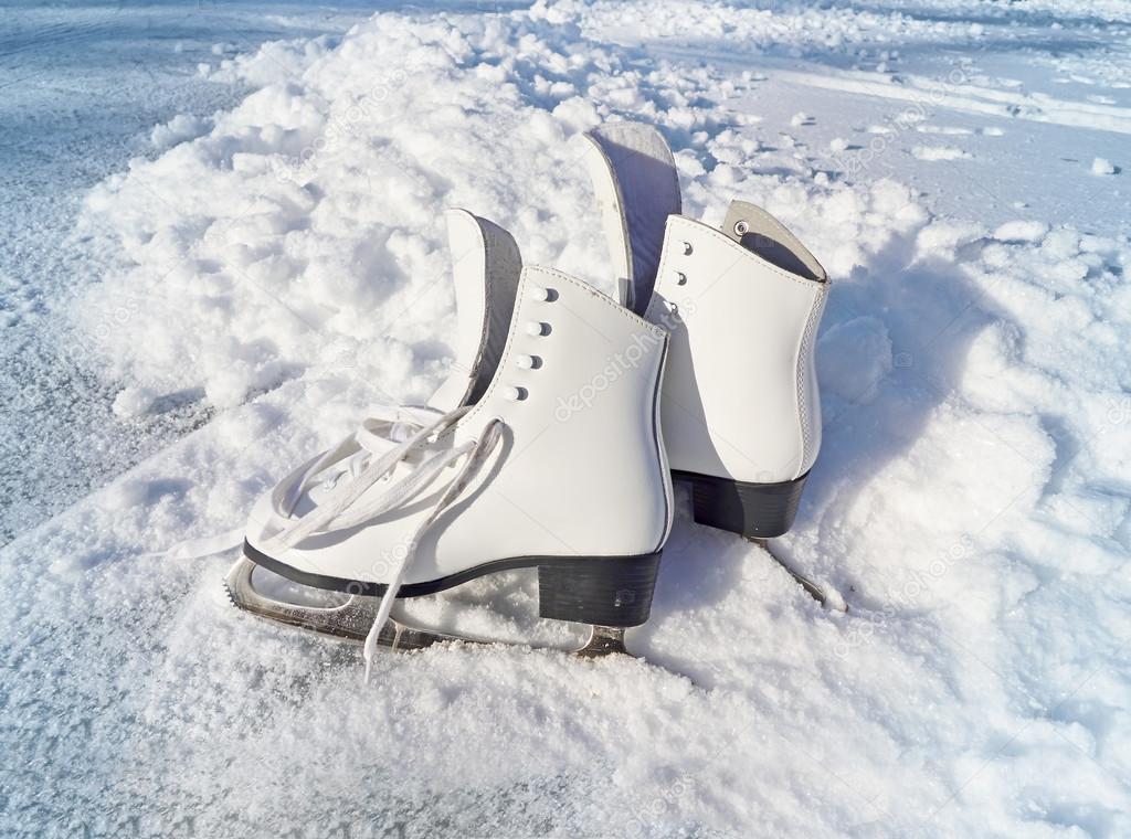 Women white skates. Abstract background on a winter sports theme