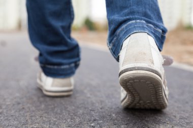 Walking in sport shoes on pavement clipart