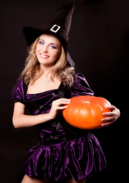 Witch with a pumpkin — Stock Photo, Image