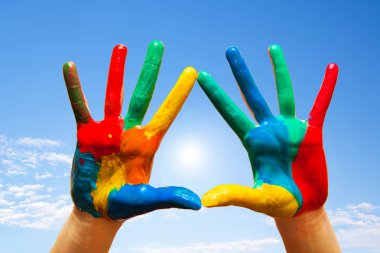 Painted hands, colorful fun. blue sky clipart