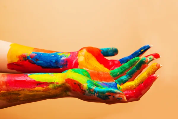 Painted hands, colorful fun. Orange background — Stock Photo, Image