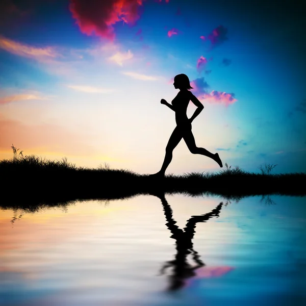 Silhouette di donna che corre al tramonto — Foto Stock