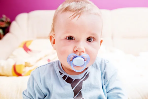 Young baby boy with a dummy in his mouth portrait — Stock Photo, Image