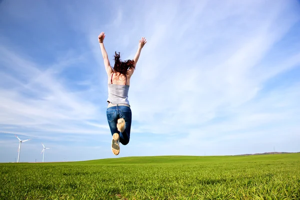 Young beautiful woman jumping for joy Stock Photo