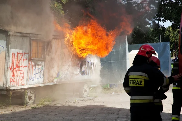 Firefighters fighting a fire of a waste place — Stock Photo, Image