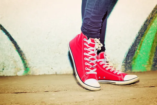 Close up of red sneakers worn by a teenager. — Stock Photo, Image