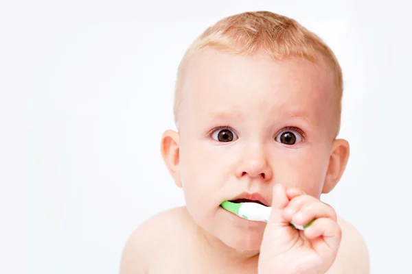 Cute baby brushing his teeth on white — Stock Photo, Image