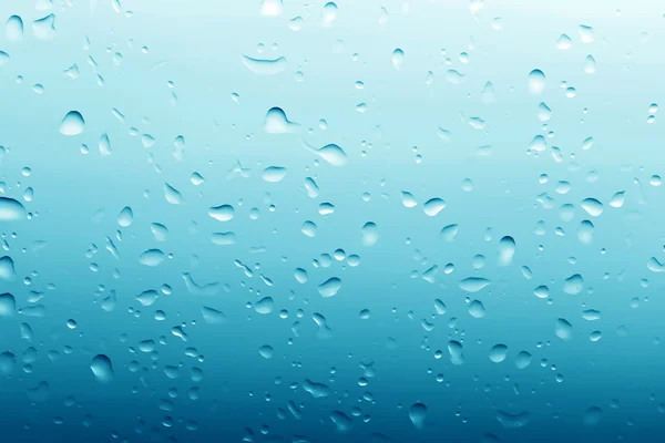 Gotas de agua sobre fondo azul de vidrio limpio — Foto de Stock