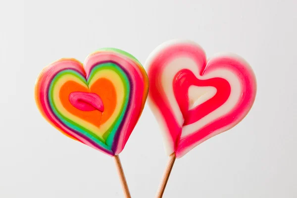 Colorful heart shaped lollipops on grey background — Stock Photo, Image