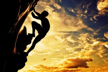 A silhouette of man free climbing on rock clipart