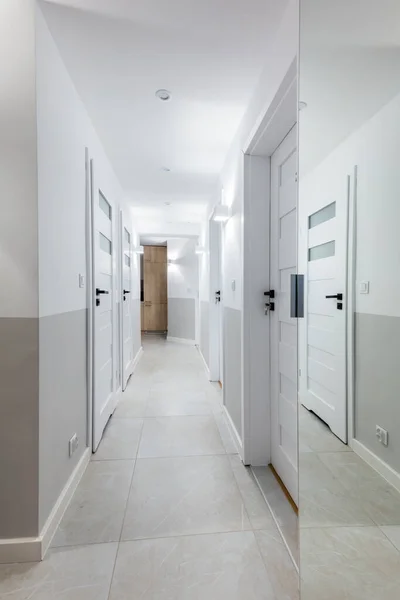 Corridor with white doors in apartment for rent