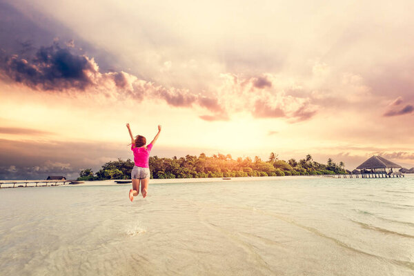 Young Woman Jumping Joy Maldives Sunset Exotic Holiday Destination Stock Photo