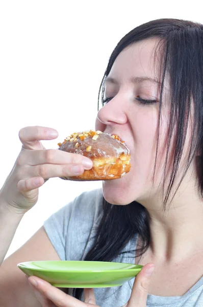 Portrait of a young woman eating a donut — Stock Photo, Image