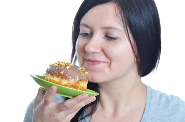 Portrait of a young woman eating a donut — Stock Photo, Image
