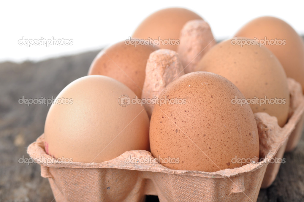 Eggs in a tray on a wooden table.