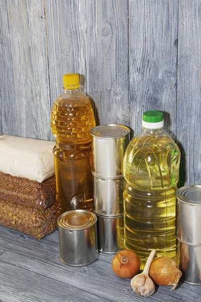 canned food and various cereals on a wooden shelf, food crisis, self-isolation, epidemic, Covid 19.