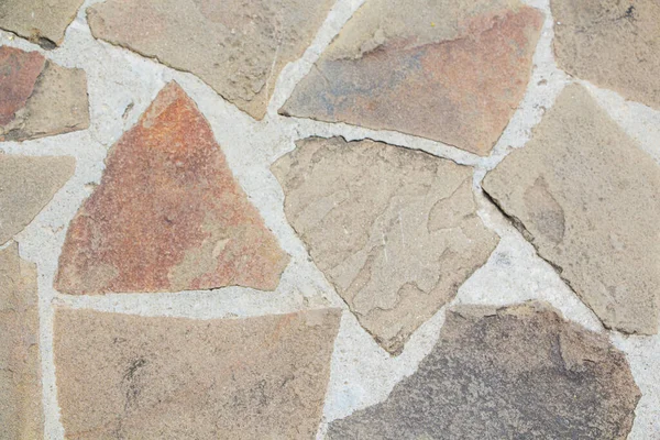 La superficie de textura áspera de la pared de piedra salvaje. Contexto. — Foto de Stock