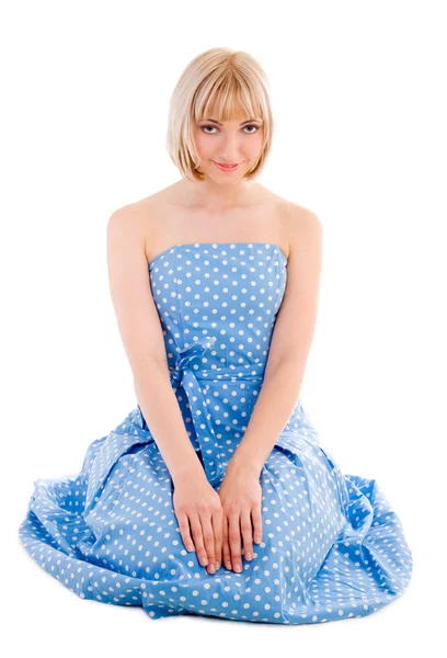 Sitting woman in blue polka dot dress — Stock Photo, Image