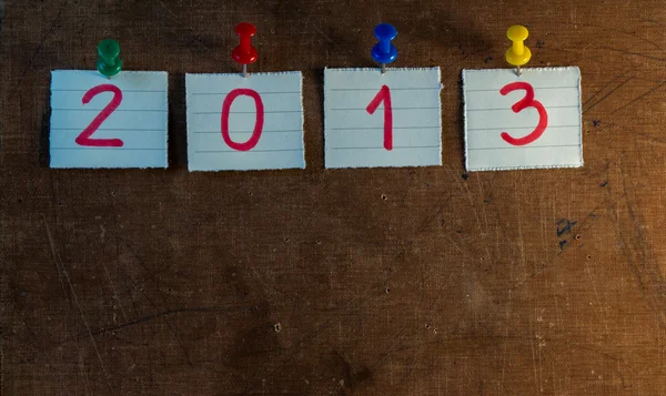 2013 on sticky note over vintage old paper background — Stock Photo, Image