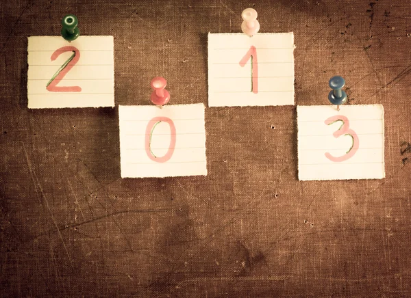 2013 on sticky note over vintage old paper background — Stock Photo, Image