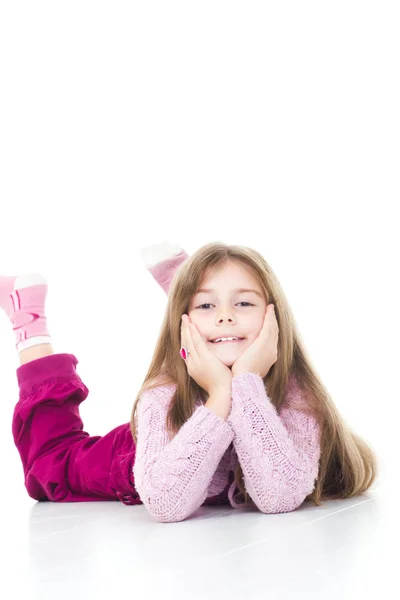 Happy little girl laying on floor-isolated over white — Stock Photo, Image