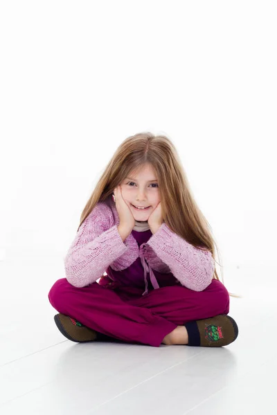 Happy little girl sitting on floor — Stock Photo, Image