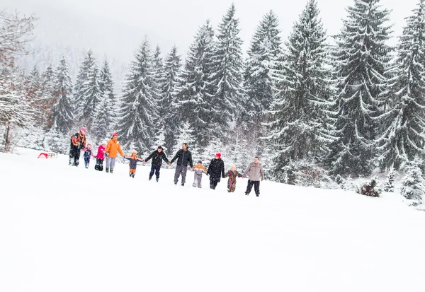 Familia divirtiéndose en la nieve — Foto de Stock