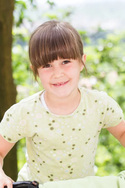 Beautiful little girl on a bicycle — Stock Photo, Image