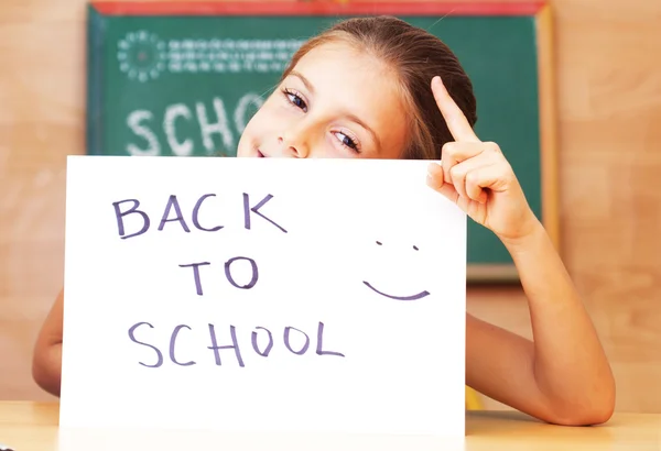 Schoolgirl in the clasroom - back to school — Stock Photo, Image