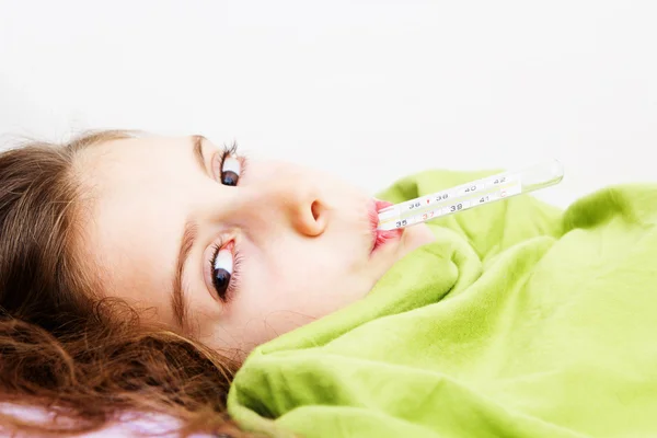 Little girl has a temperature. Laying in bed Stock Picture