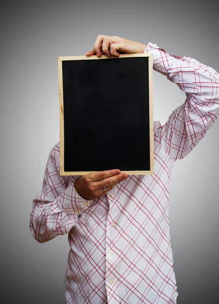 Young businessman holding blank board — Stock Photo, Image