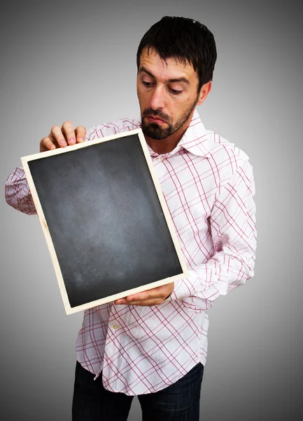 Young businessman holding blank board — Stock Photo, Image