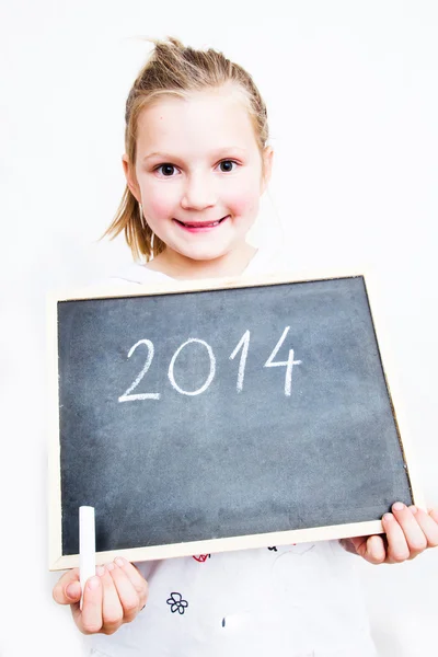 Menina segurando bordo com letras 2014. Feliz Ano Novo — Fotografia de Stock
