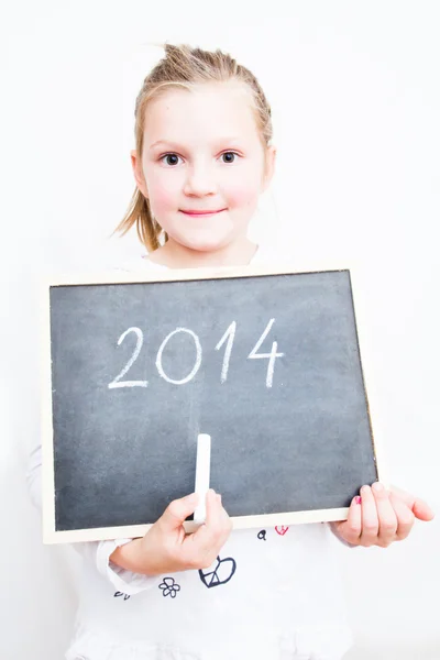 Kleines Mädchen hält Tafel mit Buchstaben 2014. frohes neues Jahr Stockbild