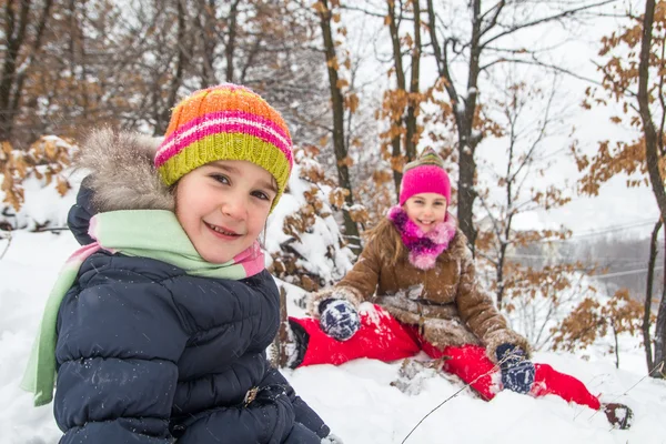 Two little girls having fun in winter — Stock Photo, Image
