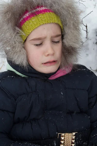 Little girl laying on the snow — Stock Photo, Image