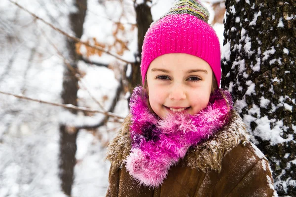 Happy little girl spending a nice time in winter forest — Stock Photo, Image