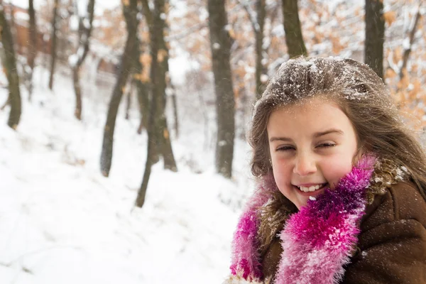 Pretty little girl with snow in her long hair — Stock Photo, Image