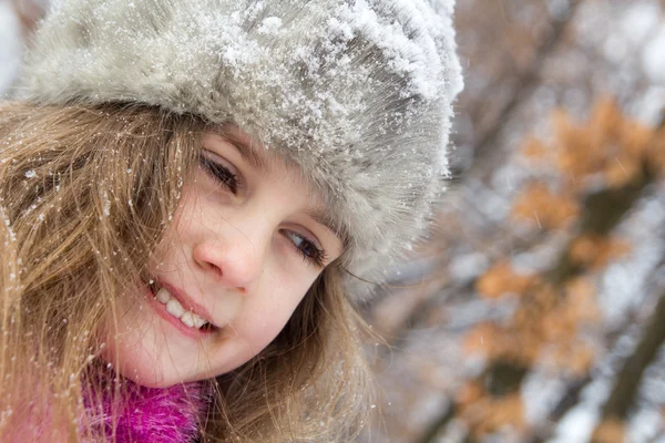 Happy little girl in warm hat - closeup portrait Stock Photo