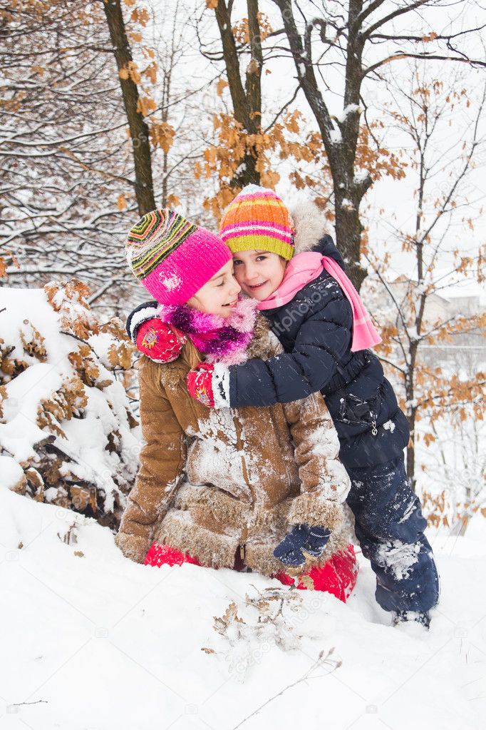 Two little girls having fun in winter