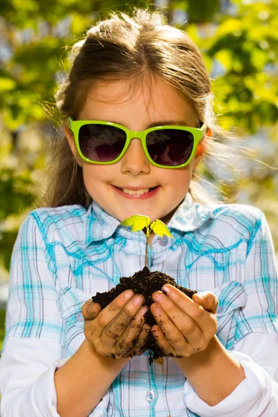 Little girl with seedling — Stock Photo, Image